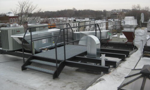 Rooftop HVAC system with surrounding railings.