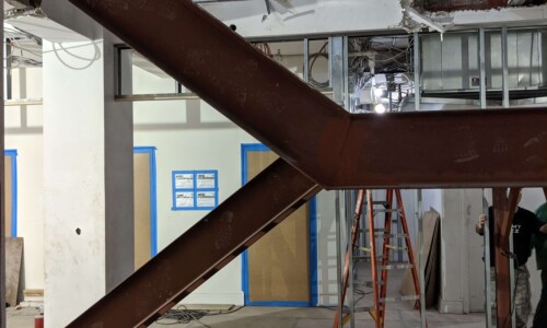 Building under construction with exposed steel beams.