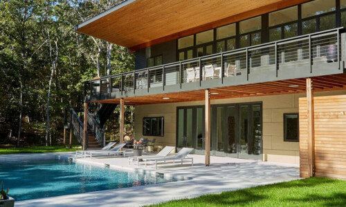 Modern house with pool and lawn.