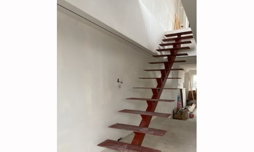 Floating staircase in modern interior under construction.