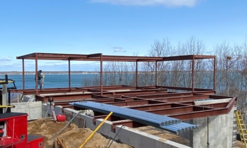 Building under construction near a body of water.