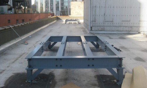 Metal frame on urban rooftop under construction.