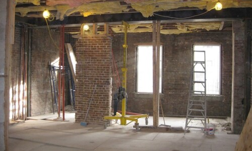 Building under renovation with exposed ceiling beams.