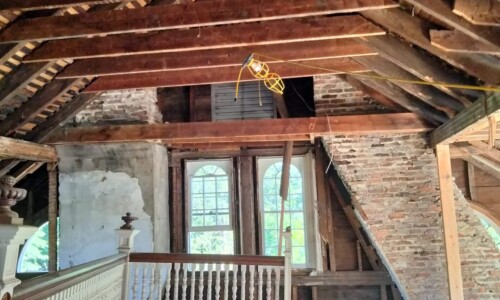 Old attic with exposed wooden beams.