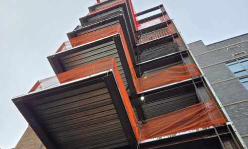 Building construction with orange safety netting.