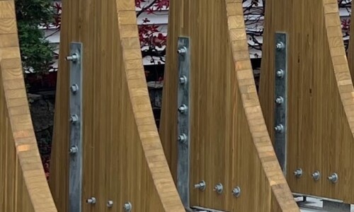 Wooden structures with metal bolts outdoors.
