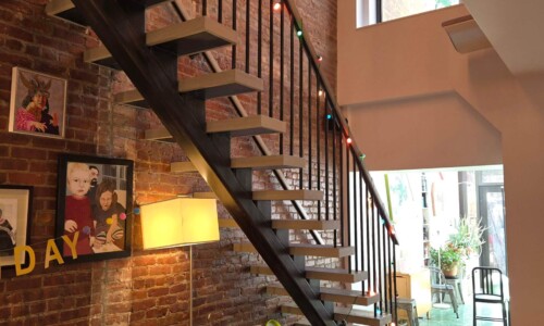 Loft apartment with modern staircase and couch.