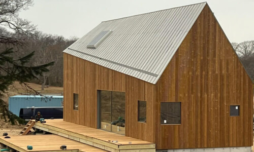 Modern wooden house with metal roof construction.