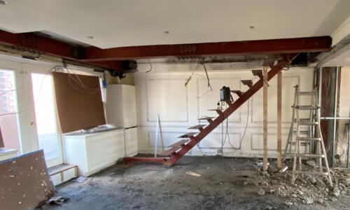 Room under renovation with exposed staircase.